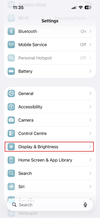 Tapping on "Display &amp; Brightness" option in iPhone Settings. 