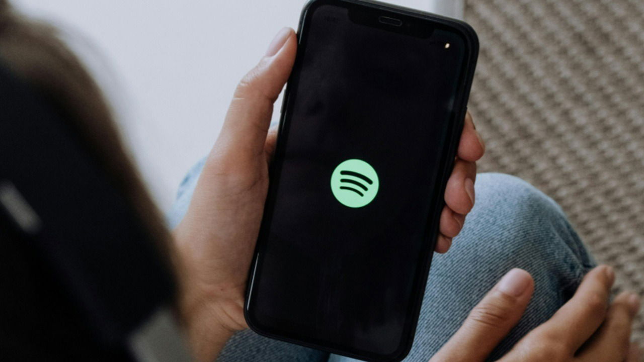 Person opening Spotify on their phone.